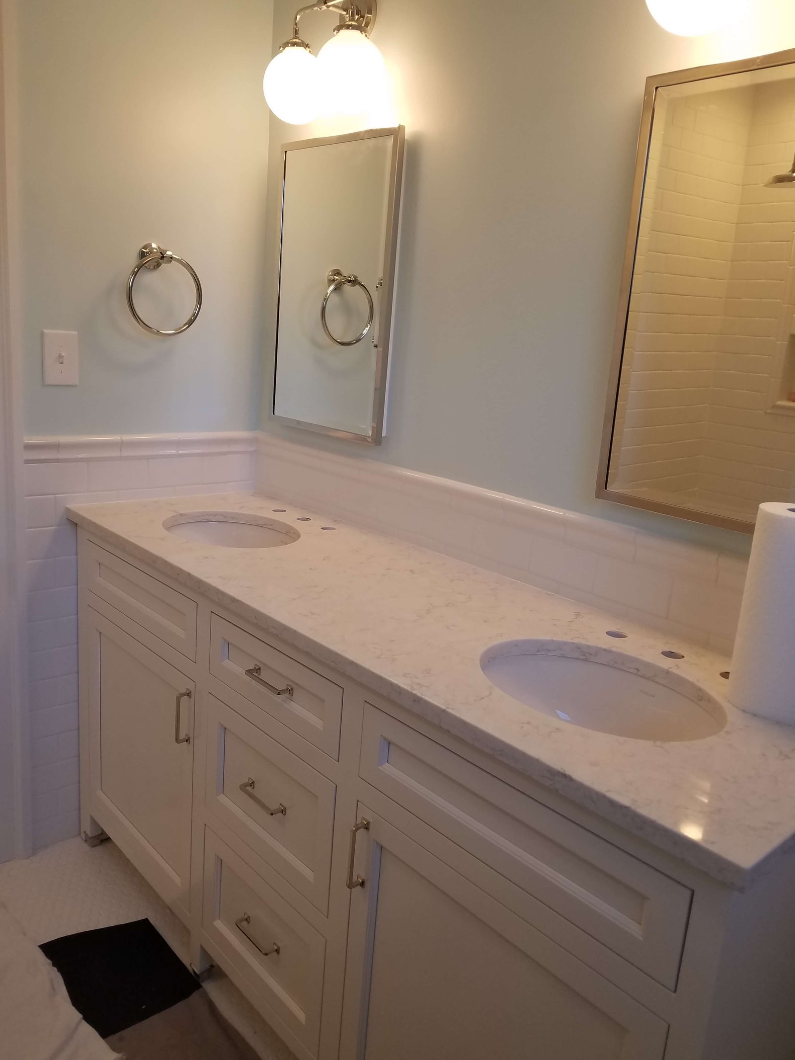 Finished double vanity with marble countertop and chrome fixtures